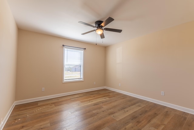 unfurnished room with ceiling fan and hardwood / wood-style floors