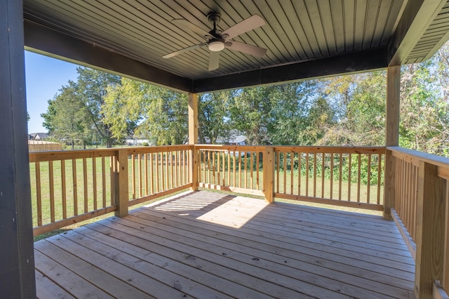 deck featuring ceiling fan and a yard