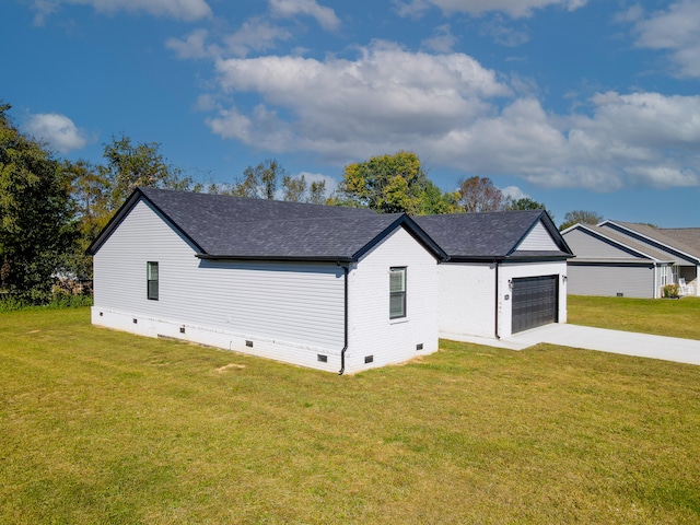 exterior space with a garage and a yard