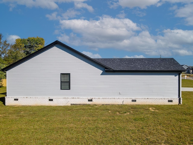 view of side of property with a lawn