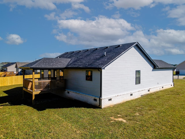 rear view of property with a lawn and a deck