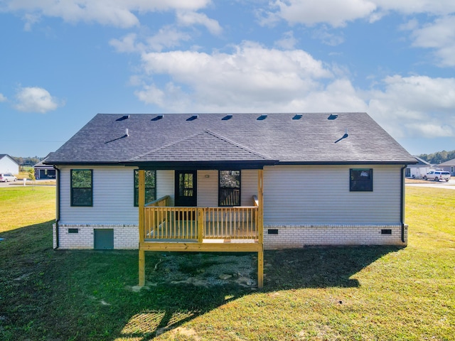 back of property with a deck and a lawn