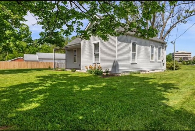 back of property with a lawn