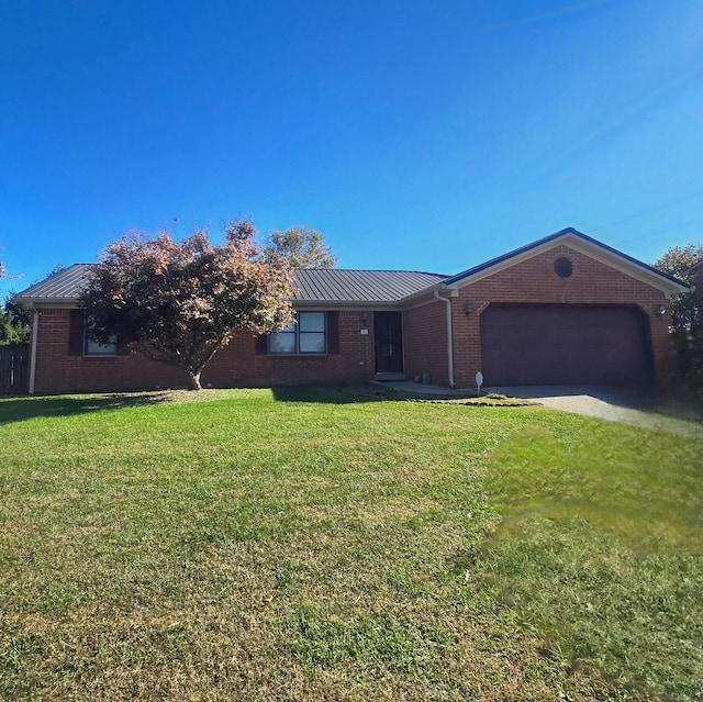 ranch-style house featuring a front yard and a garage