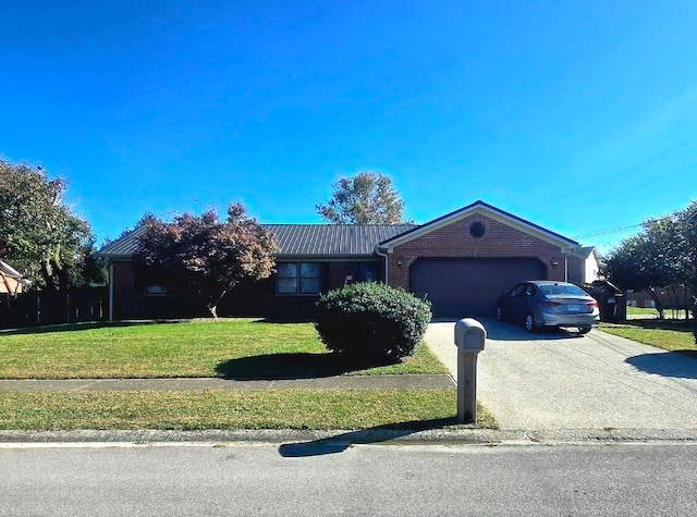 ranch-style home with a garage and a front lawn