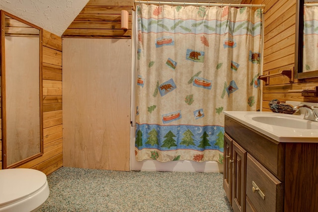 bathroom with toilet, wood walls, vanity, and curtained shower