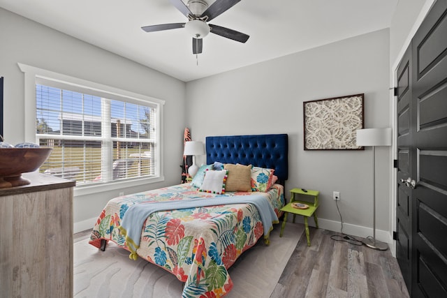 bedroom with ceiling fan and hardwood / wood-style floors