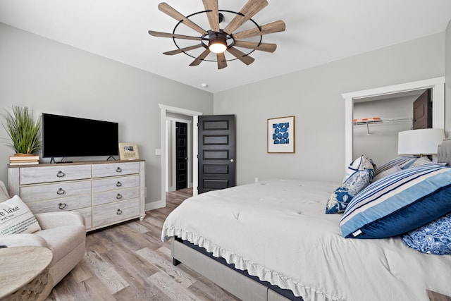 bedroom with ceiling fan, a closet, and light hardwood / wood-style floors