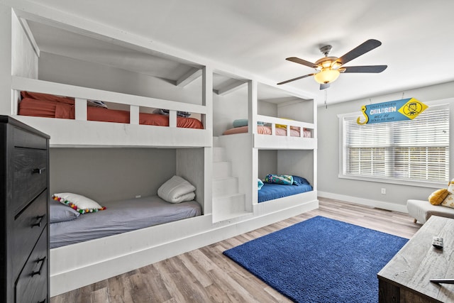 bedroom with hardwood / wood-style floors and ceiling fan