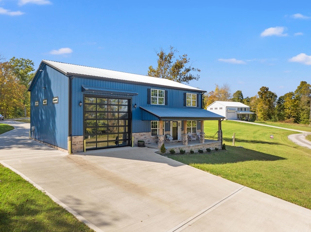 view of front of property featuring a garage, a porch, and a front lawn