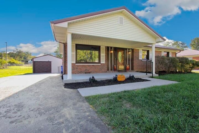 bungalow with a garage, a front yard, and covered porch