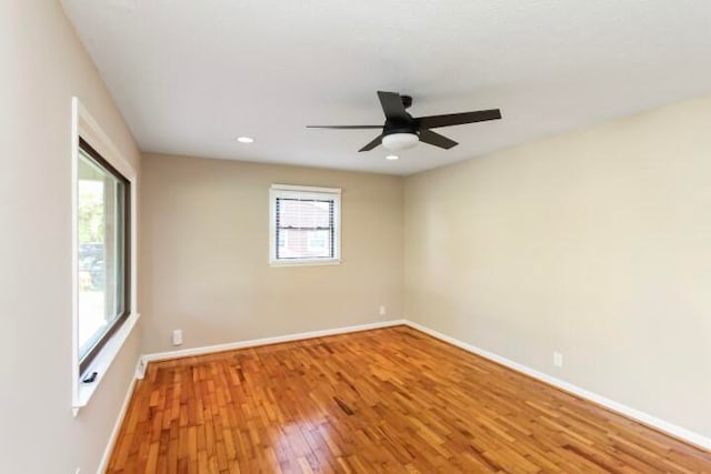 spare room with hardwood / wood-style flooring and ceiling fan