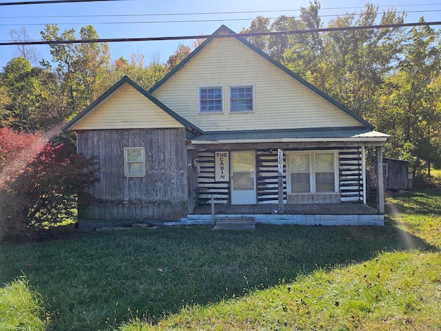 log-style house with a front lawn and covered porch