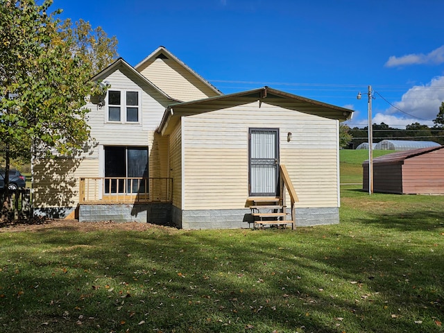 rear view of property with a lawn