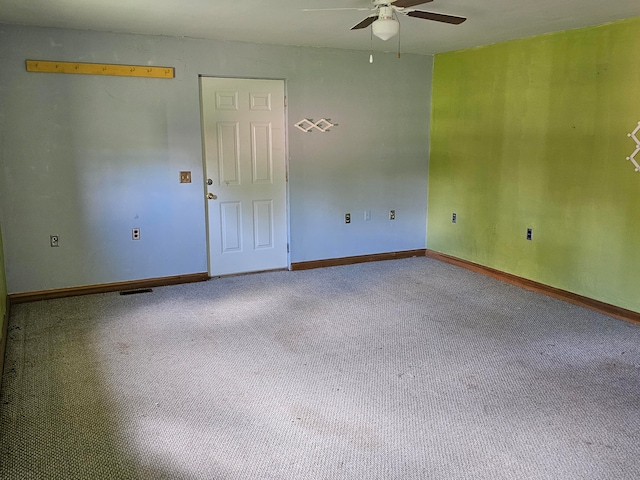 carpeted spare room with ceiling fan