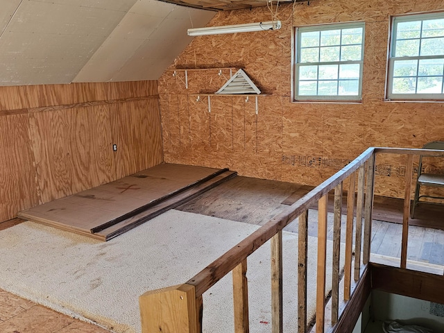 additional living space featuring lofted ceiling