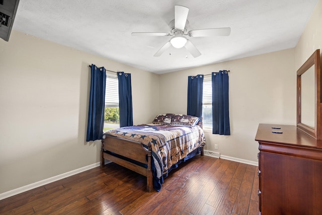 bedroom featuring ceiling fan, a textured ceiling, and dark hardwood / wood-style flooring