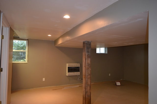 basement featuring a healthy amount of sunlight and heating unit