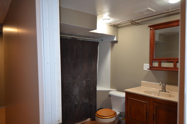 bathroom featuring vanity, a shower with shower curtain, and toilet