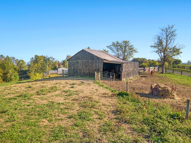 view of yard featuring an outbuilding and a rural view