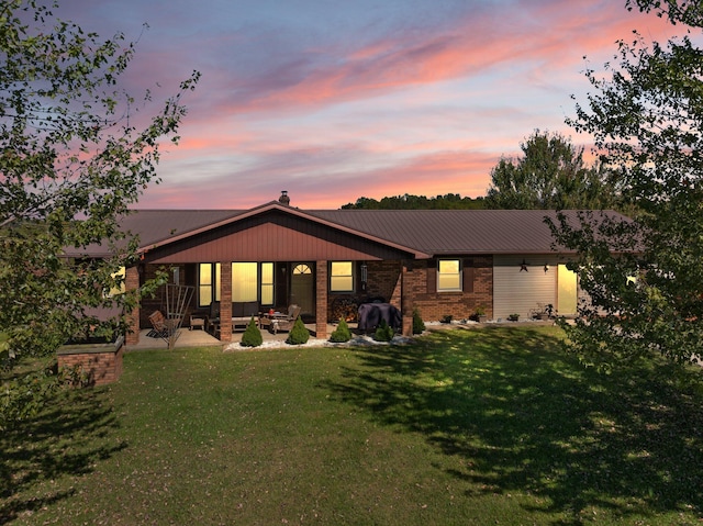 back house at dusk with a yard