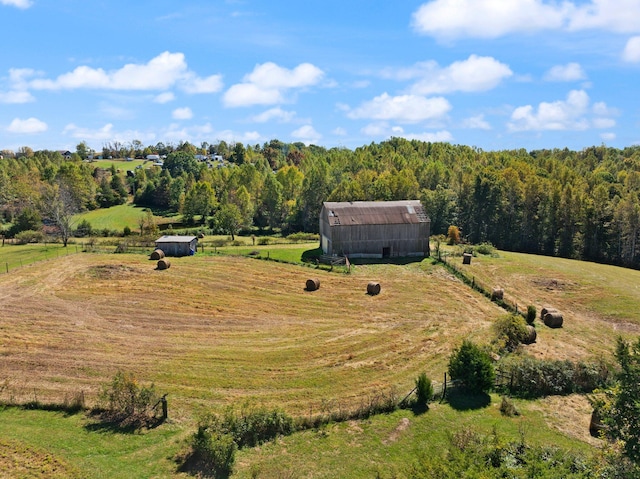 birds eye view of property with a rural view