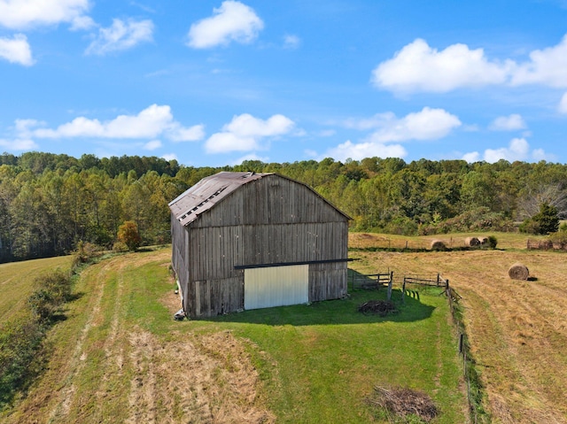 view of outdoor structure featuring a yard and a rural view