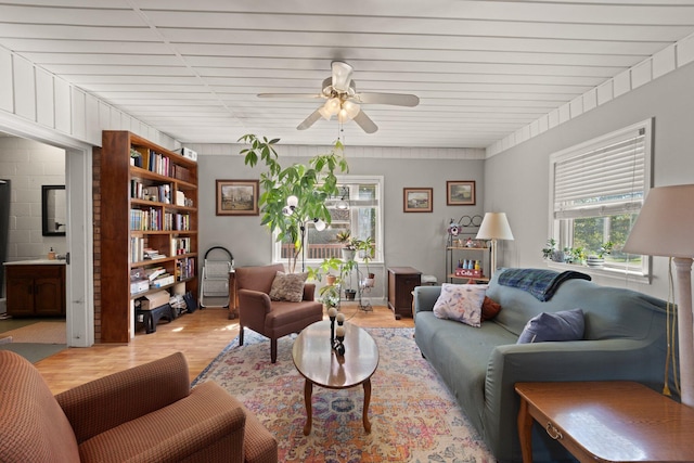 living room featuring ceiling fan and light hardwood / wood-style floors