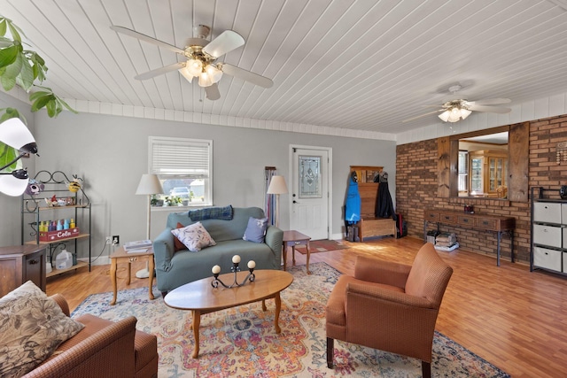 living room with ceiling fan, wooden ceiling, and light hardwood / wood-style floors