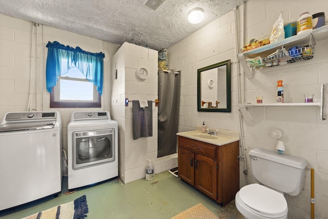 interior space featuring separate washer and dryer, sink, and a textured ceiling