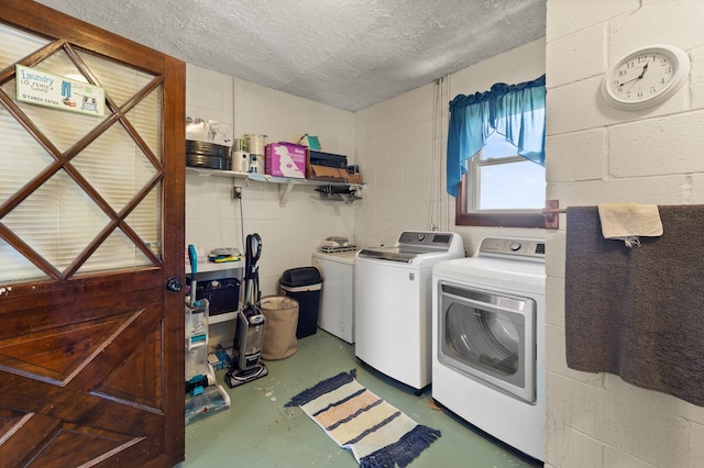 clothes washing area featuring independent washer and dryer and a textured ceiling