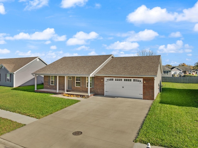 view of front of property with covered porch, a garage, and a front lawn