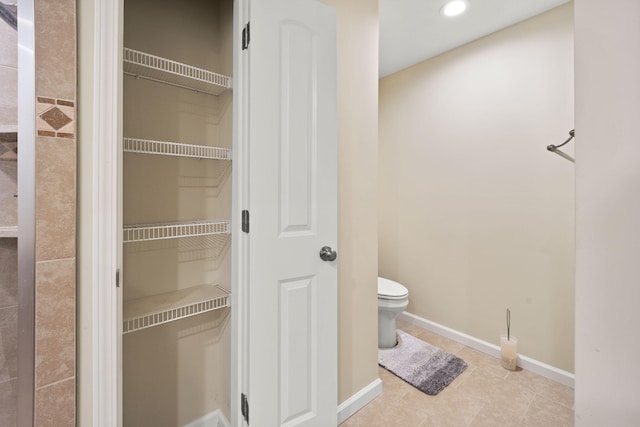 bathroom featuring tile patterned floors and toilet