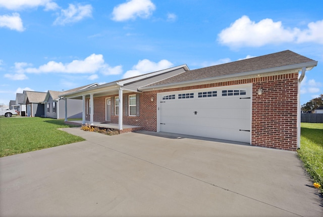 single story home featuring covered porch, a garage, and a front yard