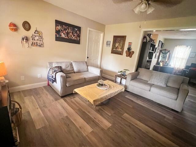 living room with wood-type flooring and ceiling fan