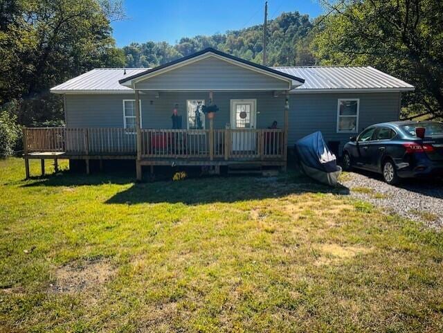 view of front of house with a front lawn and a deck