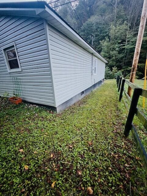 view of side of home featuring a yard