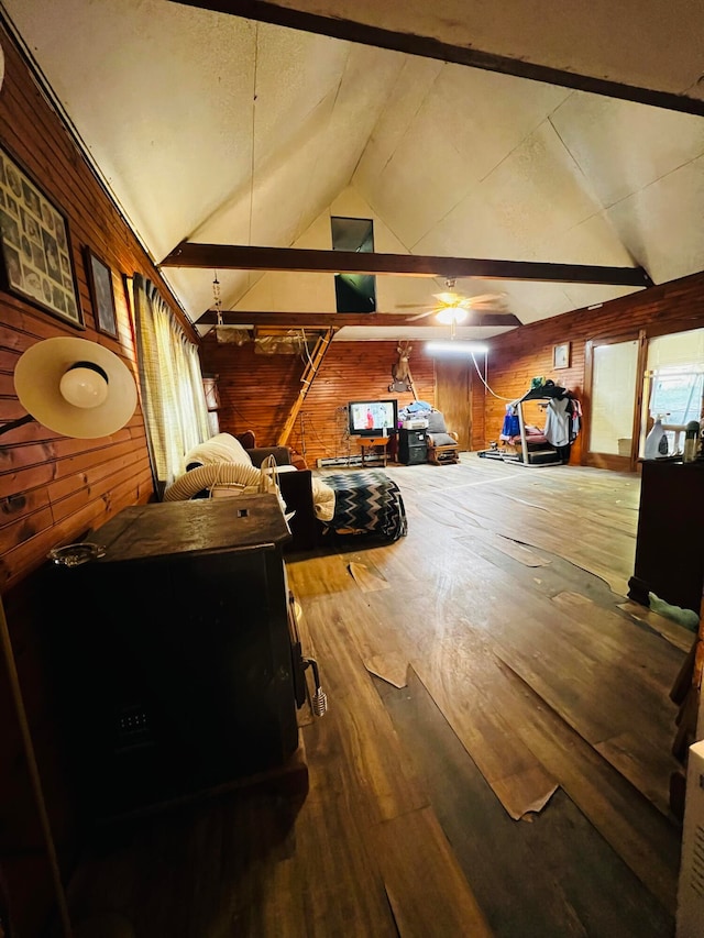 interior space featuring ceiling fan and wooden walls