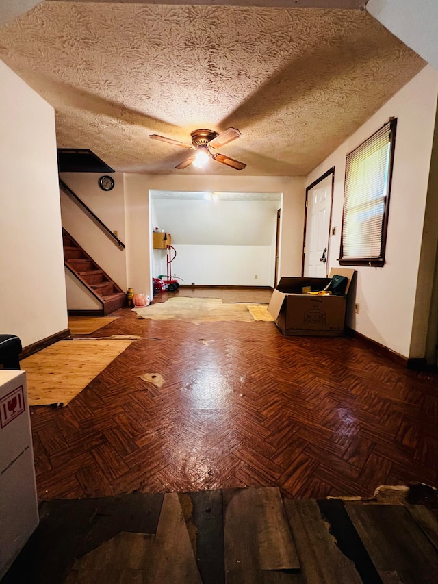 interior space with parquet flooring, a textured ceiling, and ceiling fan