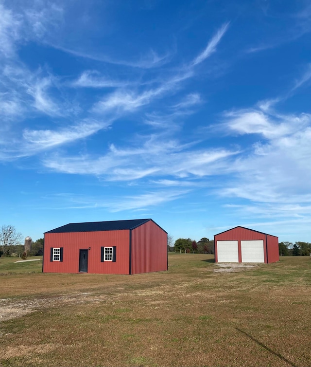 view of outdoor structure featuring a yard and a garage