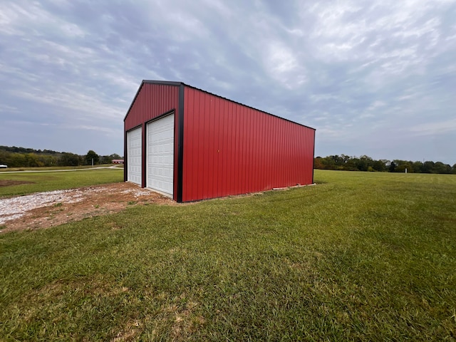 view of outbuilding with a garage and a lawn