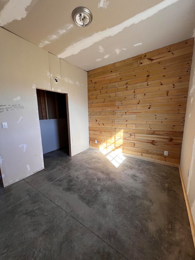 spare room with wooden walls