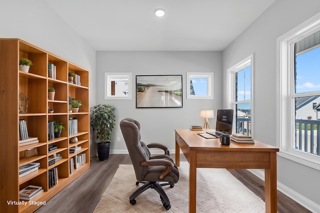 office with healthy amount of natural light, wood finished floors, and baseboards