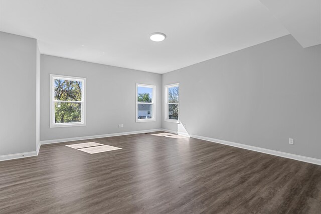 unfurnished living room with dark hardwood / wood-style flooring