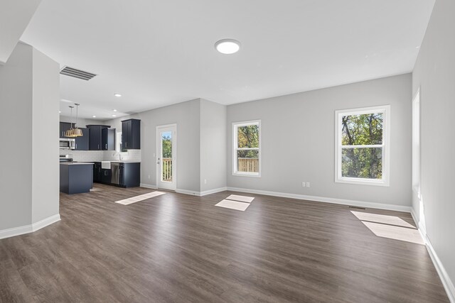 unfurnished living room with dark wood-type flooring