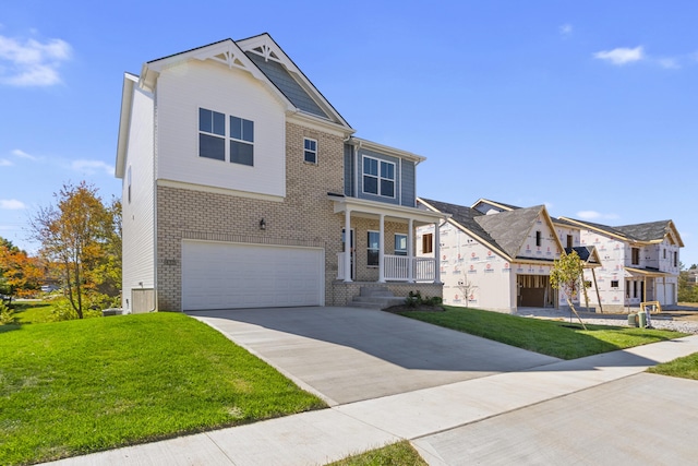 view of front of home with a front lawn, a porch, and a garage