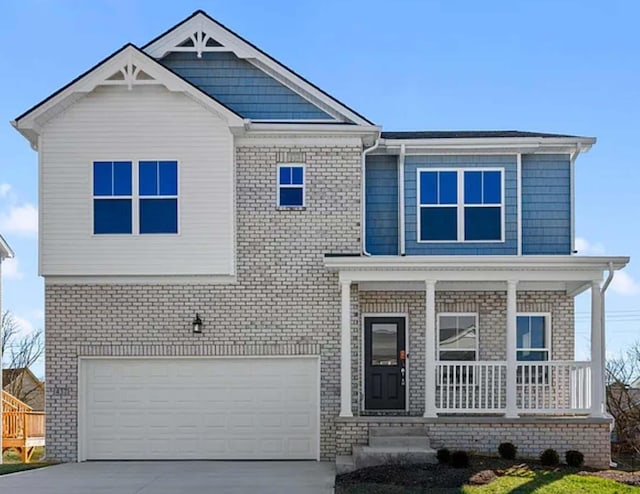 craftsman-style house with covered porch, driveway, brick siding, and an attached garage