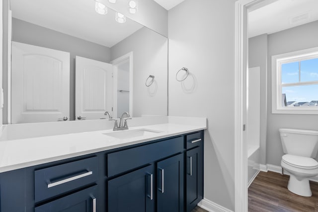 full bath with visible vents, baseboards, toilet, wood finished floors, and vanity