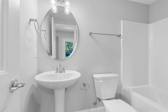 bathroom with bathing tub / shower combination and toilet