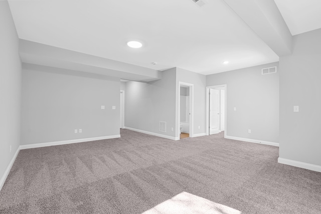 carpeted empty room featuring visible vents and baseboards